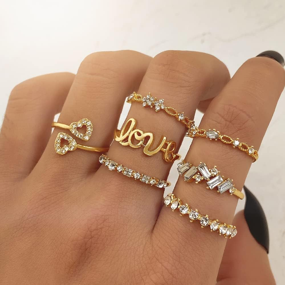 Gold stacking rings set on woman's hand showing full collection