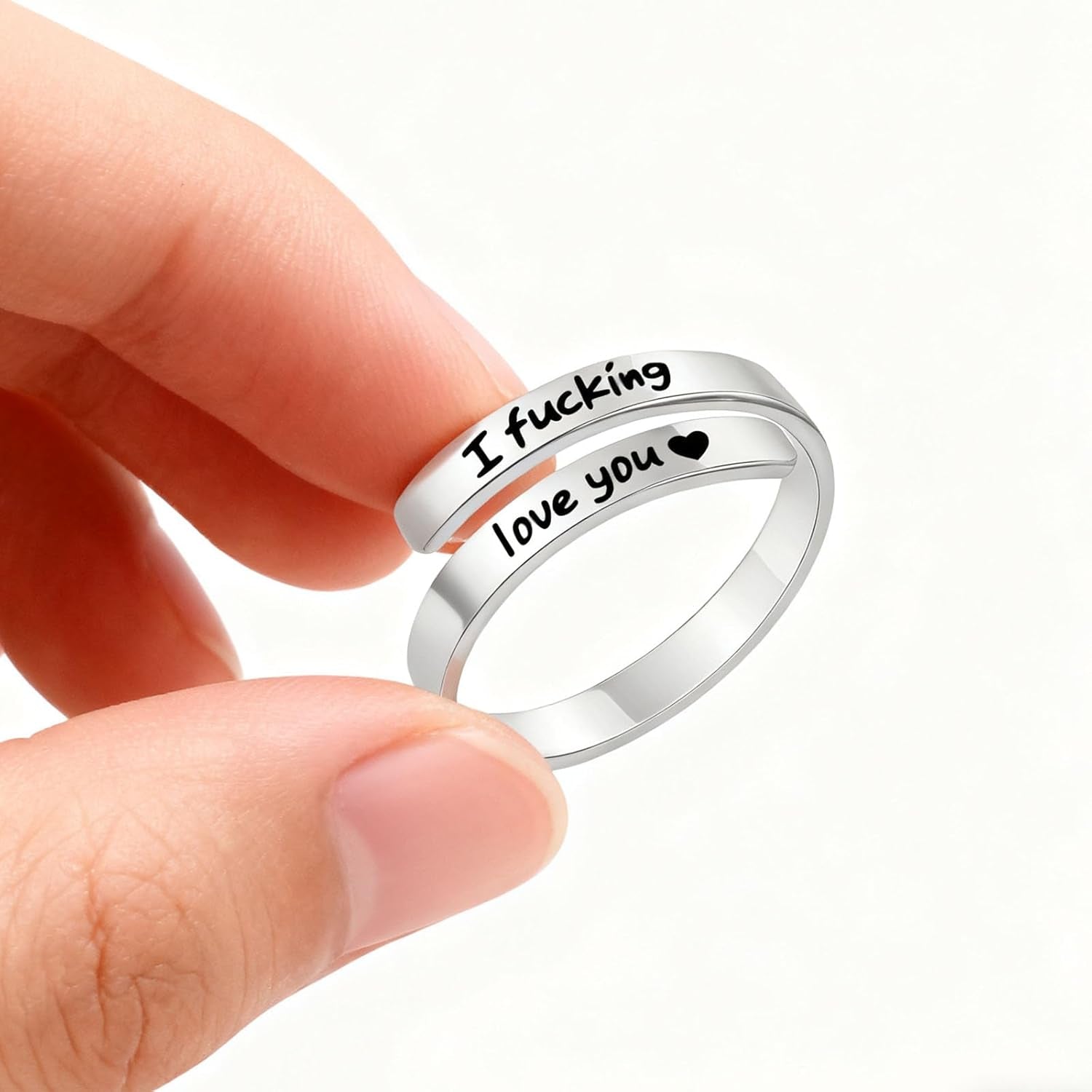 Close-up of engraved heart detail on I Fcking Need You promise ring