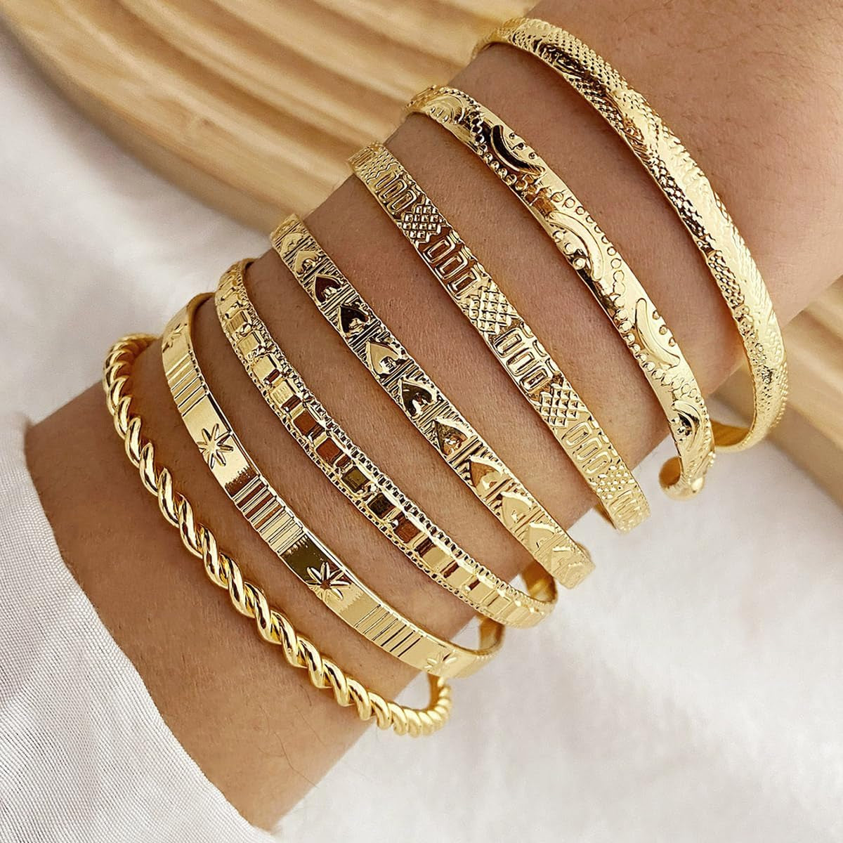 Multi-layer gold cuff bracelets in boho style stacked together