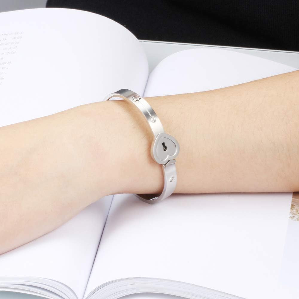 Woman and man wearing matching heart key lock bangles