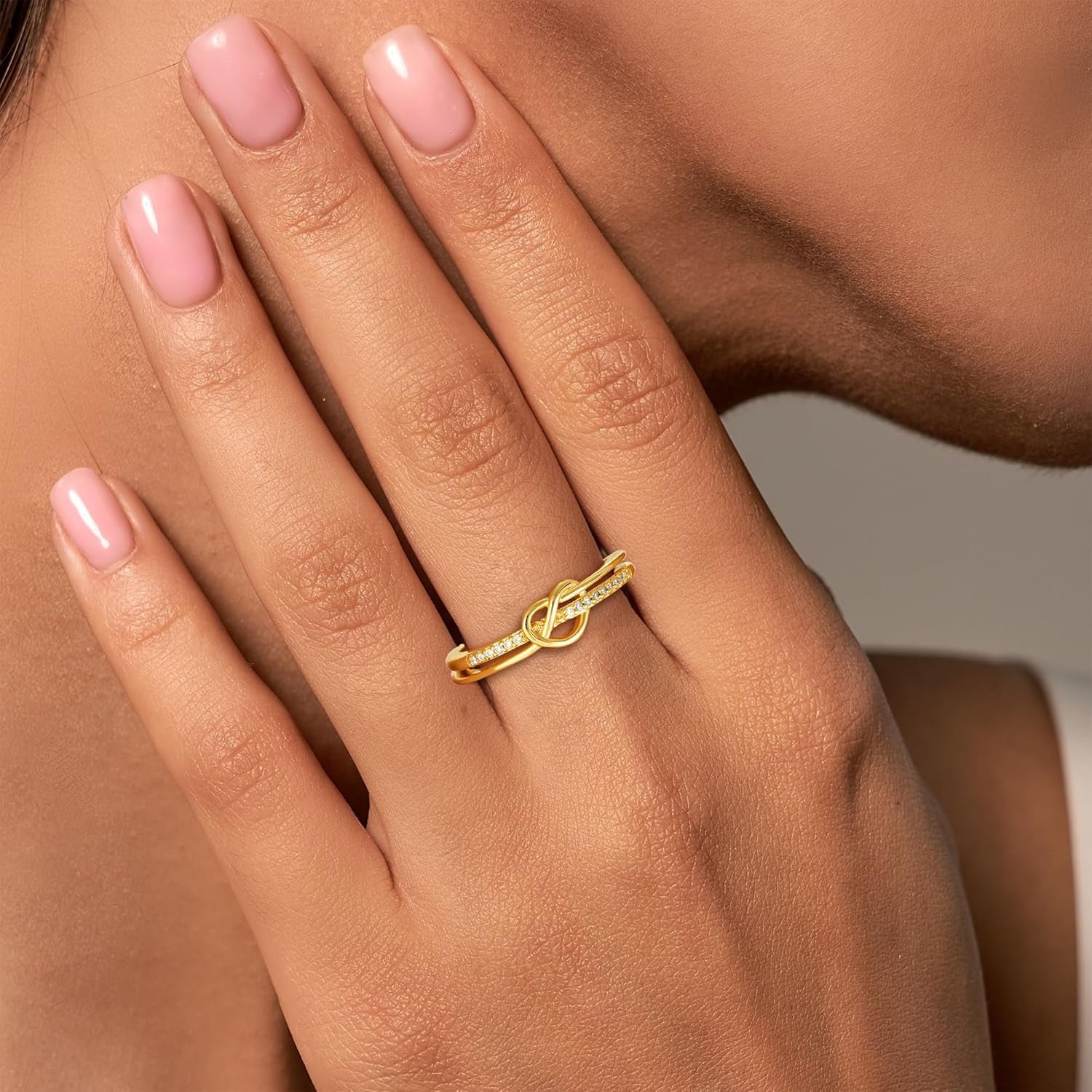 Gold love knot ring with cubic zirconia gemstone detail view