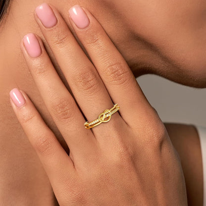 Gold love knot ring with cubic zirconia gemstone detail view