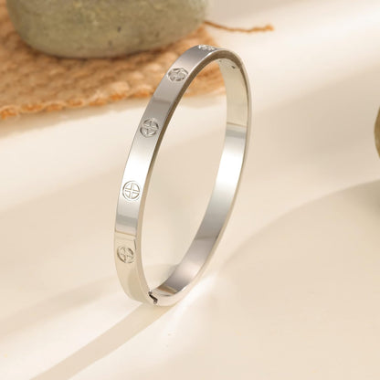 Layered gold plated love bracelets stacked together showing classic design