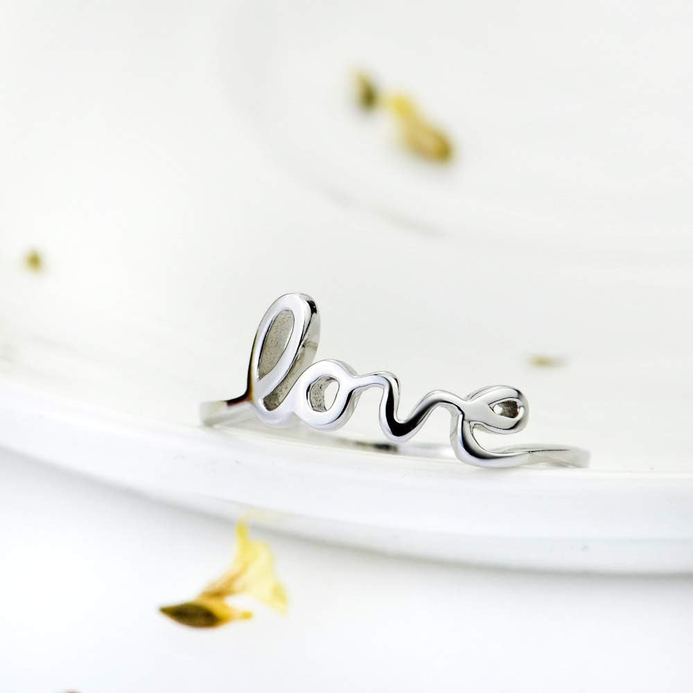 Love script promise ring on woman's finger showcasing fit
