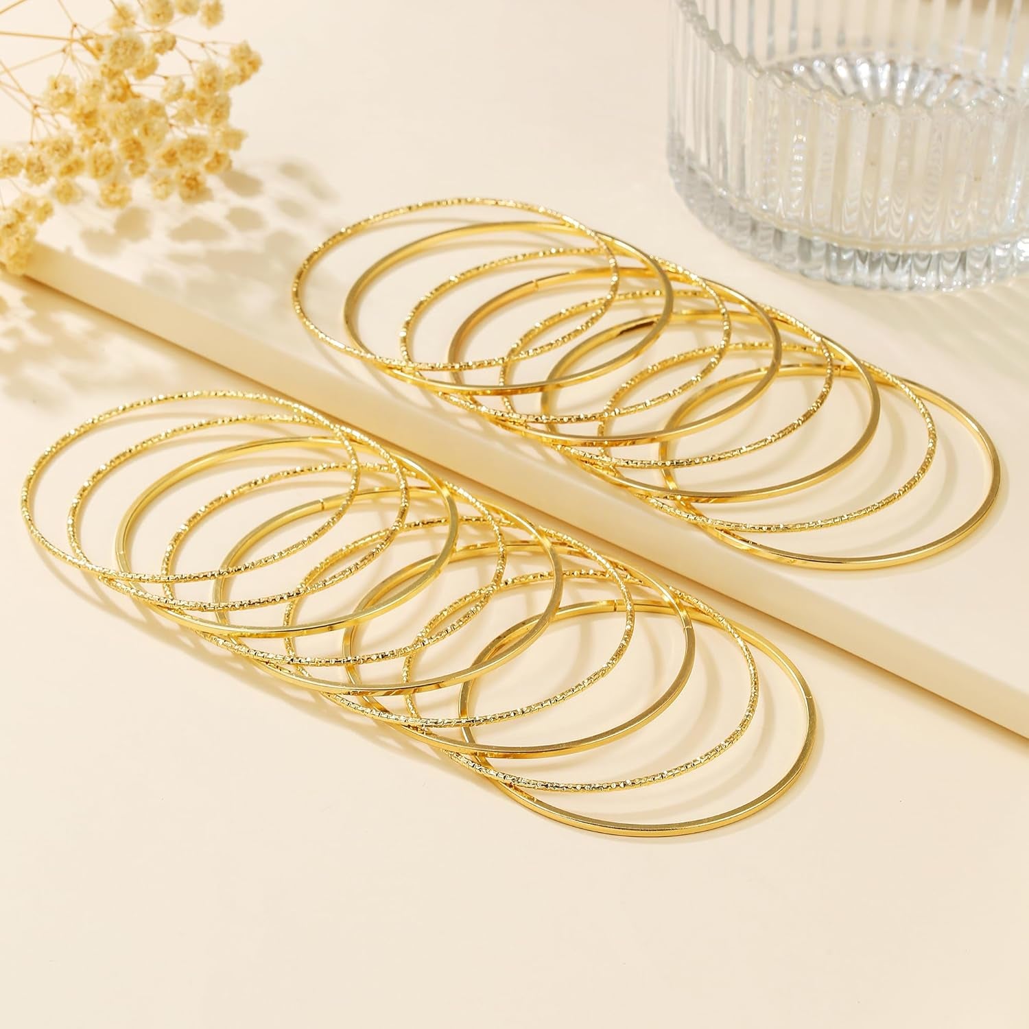 Individual textured gold bangle bracelet from twelve-piece set
