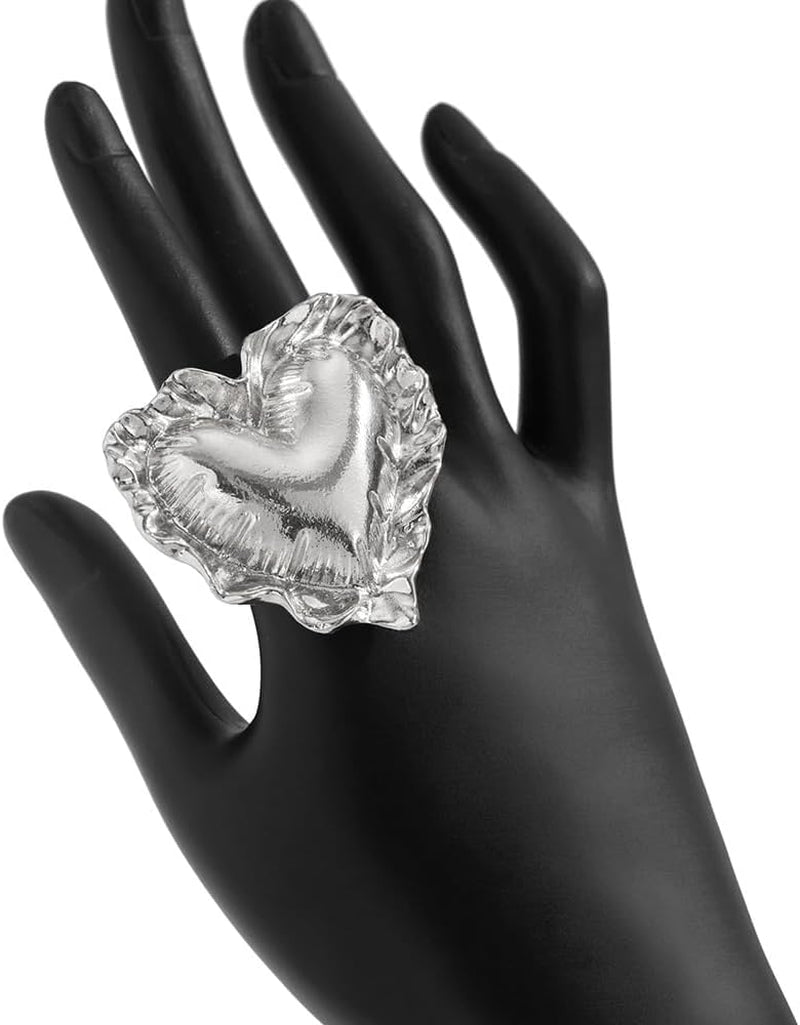 Chunky aesthetic heart ring worn on woman's finger