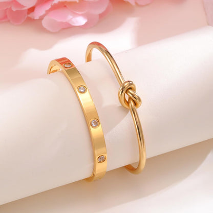 Woman wearing complete stackable gold plated bracelet set