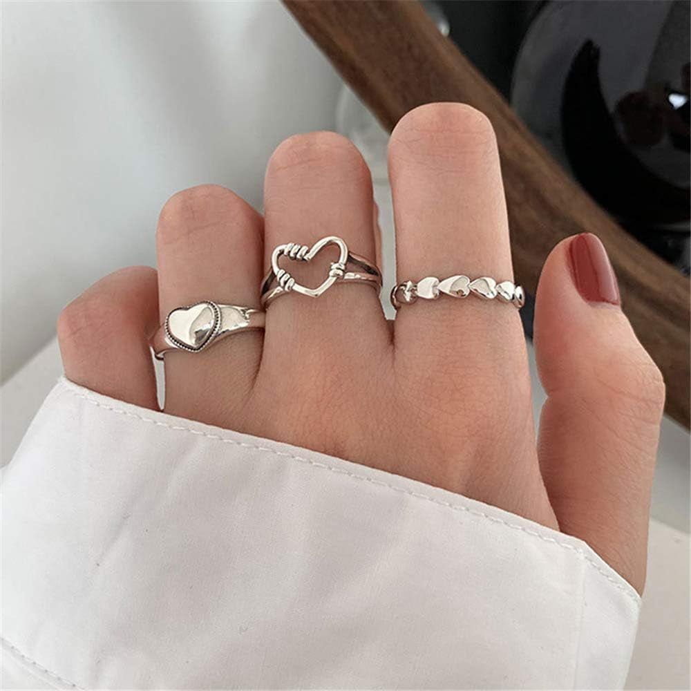 Stacking vintage heart rings worn together on female hand