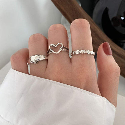 Stacking vintage heart rings worn together on female hand