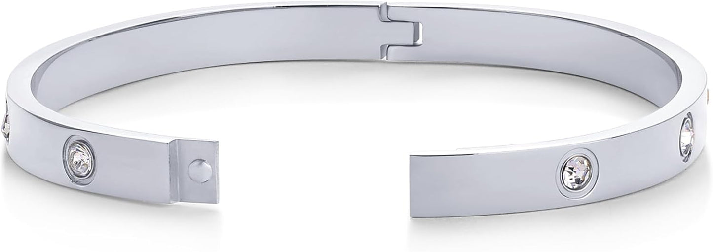 Stackable gold plated love bangles worn together on wrist
