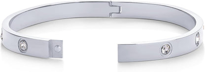 Stackable gold plated love bangles worn together on wrist