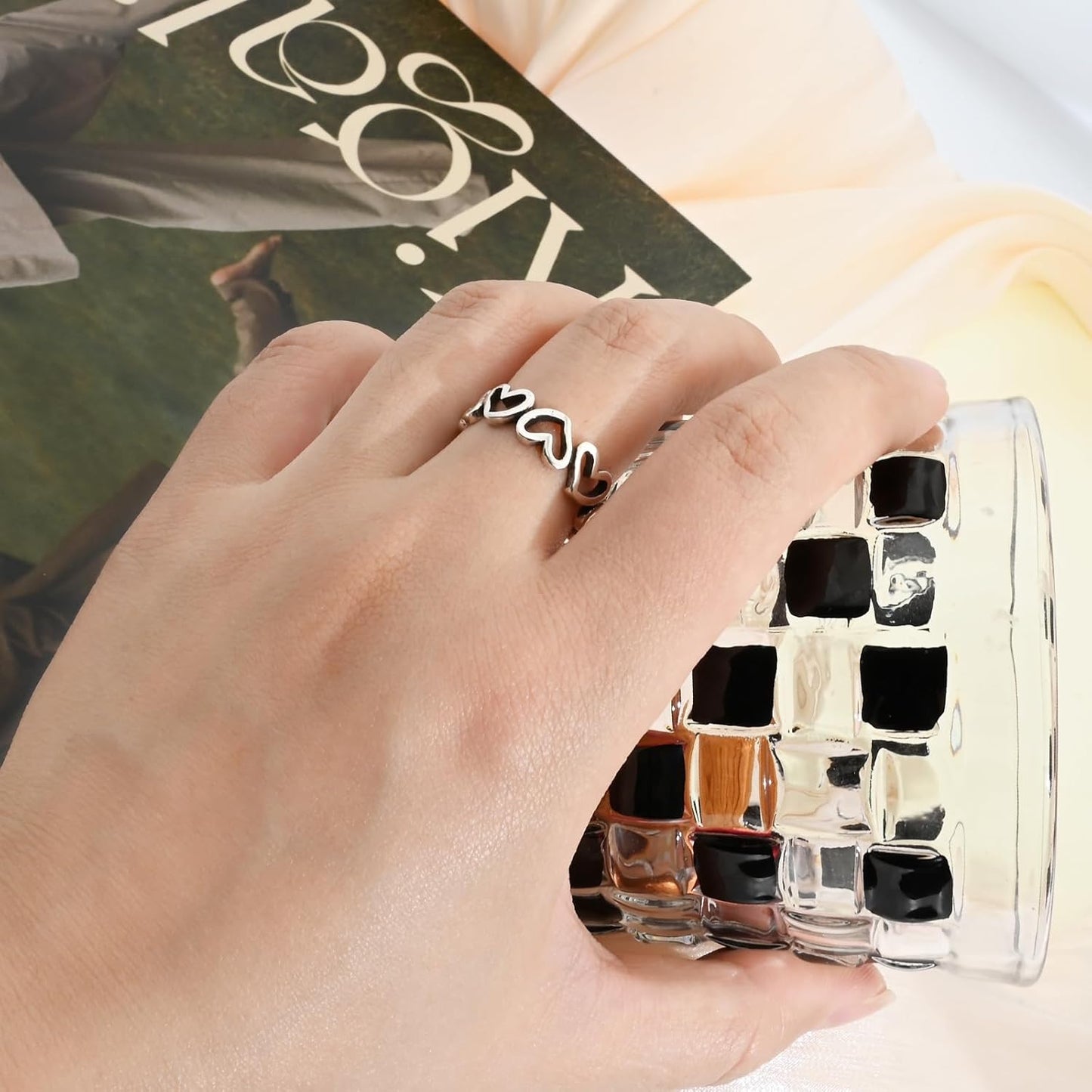 Minimalist open heart ring worn as statement thumb ring