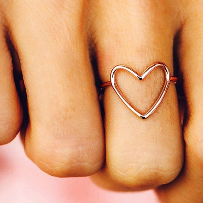 Hollow heart ring on woman's hand showing delicate minimalist fashion look
