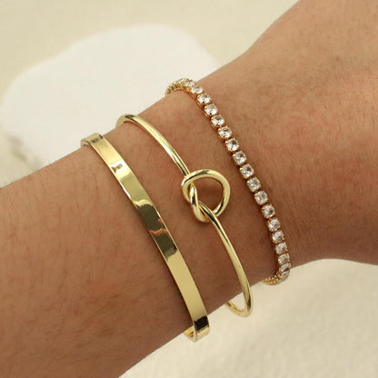 Set of gold layered cuff bracelets for women stacked together