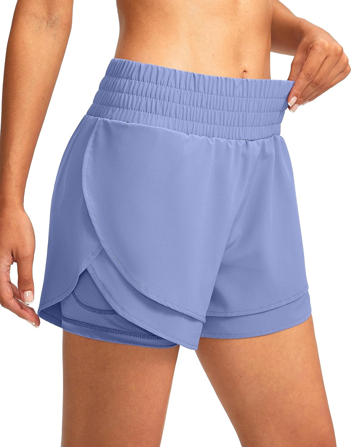 Flat lay of women's high waisted running shorts showing layered construction design