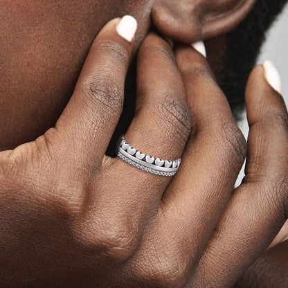 Multiple KEQ heart rings stacked together on female finger