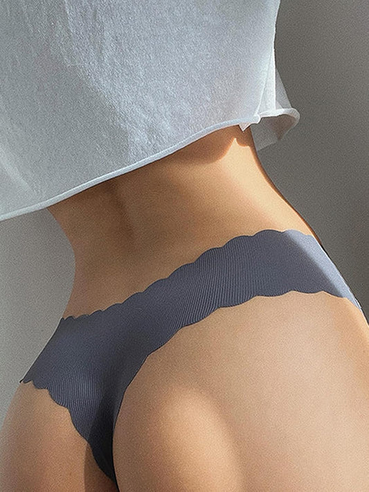 Three pack seamless thongs with wavy edge design displayed