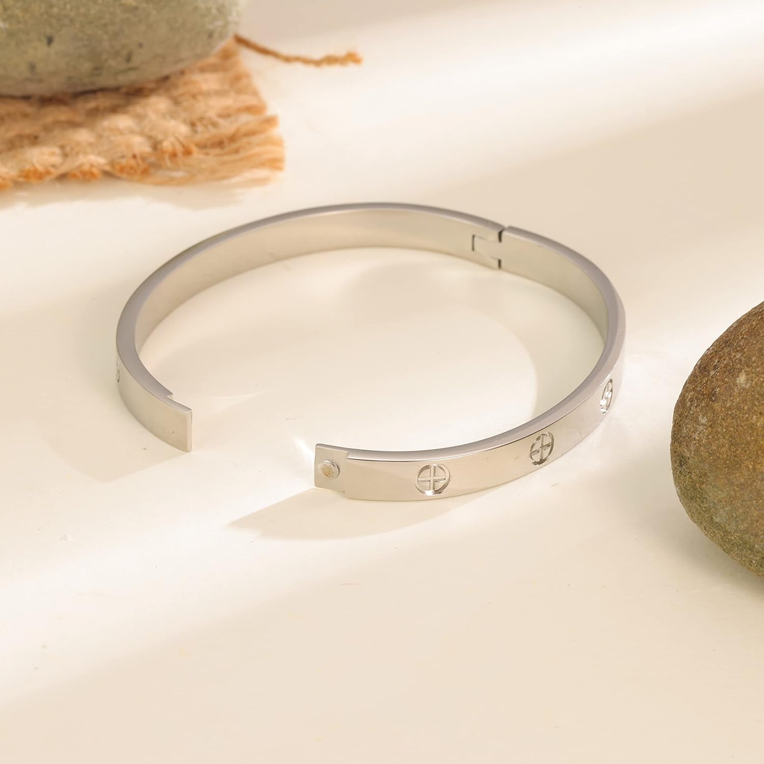 Rose gold tone love bracelet cuff displayed on model wrist