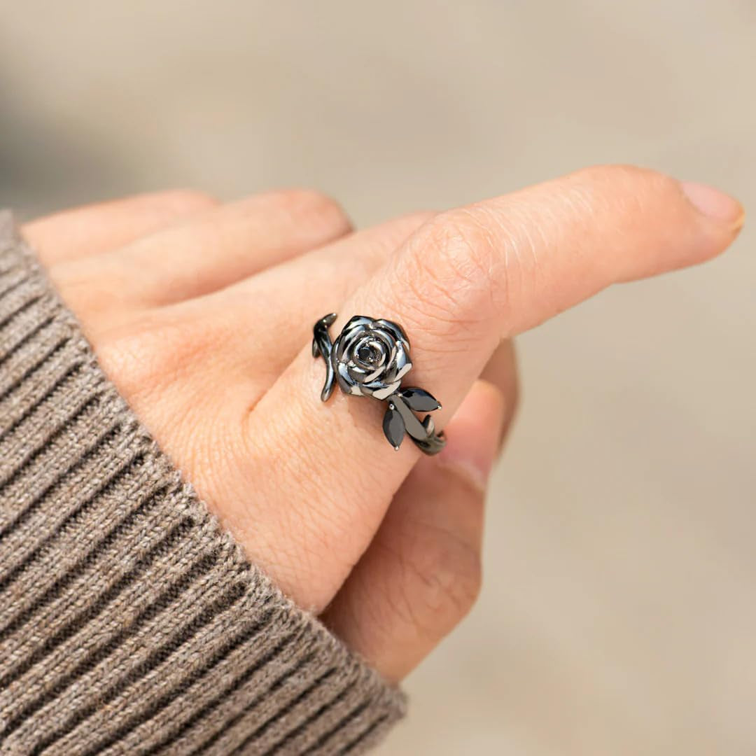 Dainty black rose ring blooming from darkness symbolizing strength