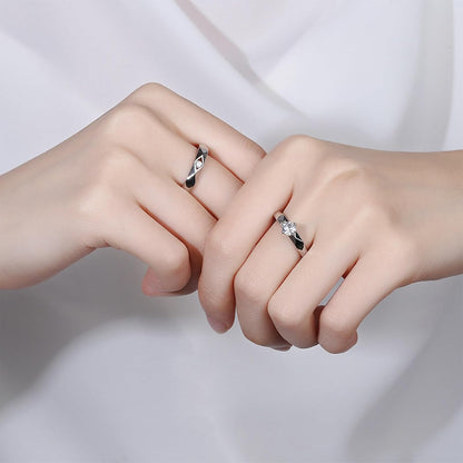 His and hers adjustable silver couple rings worn together