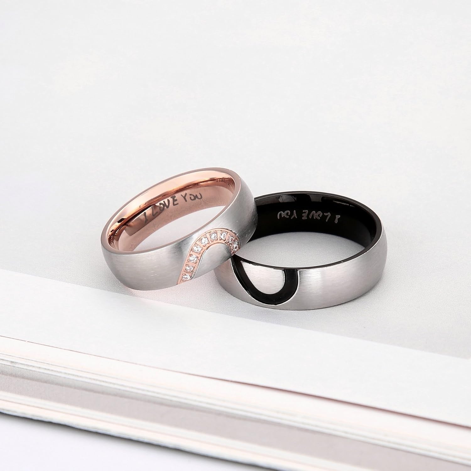 Stainless steel couples engagement bands displayed side by side