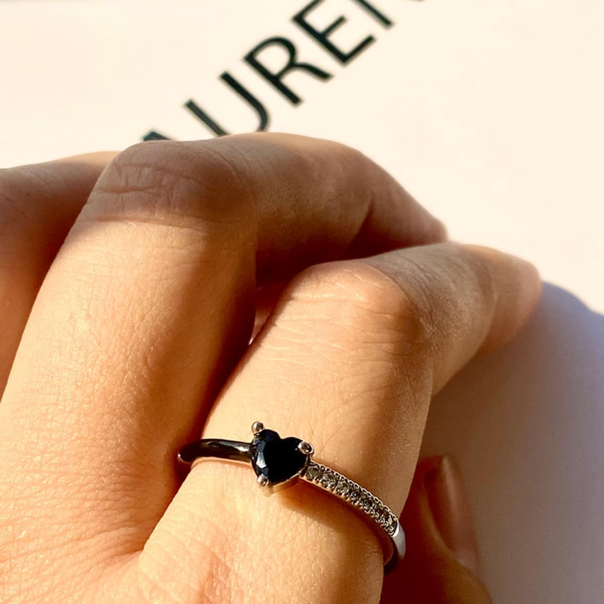 Close-up of black heart enamel detail on adjustable love ring