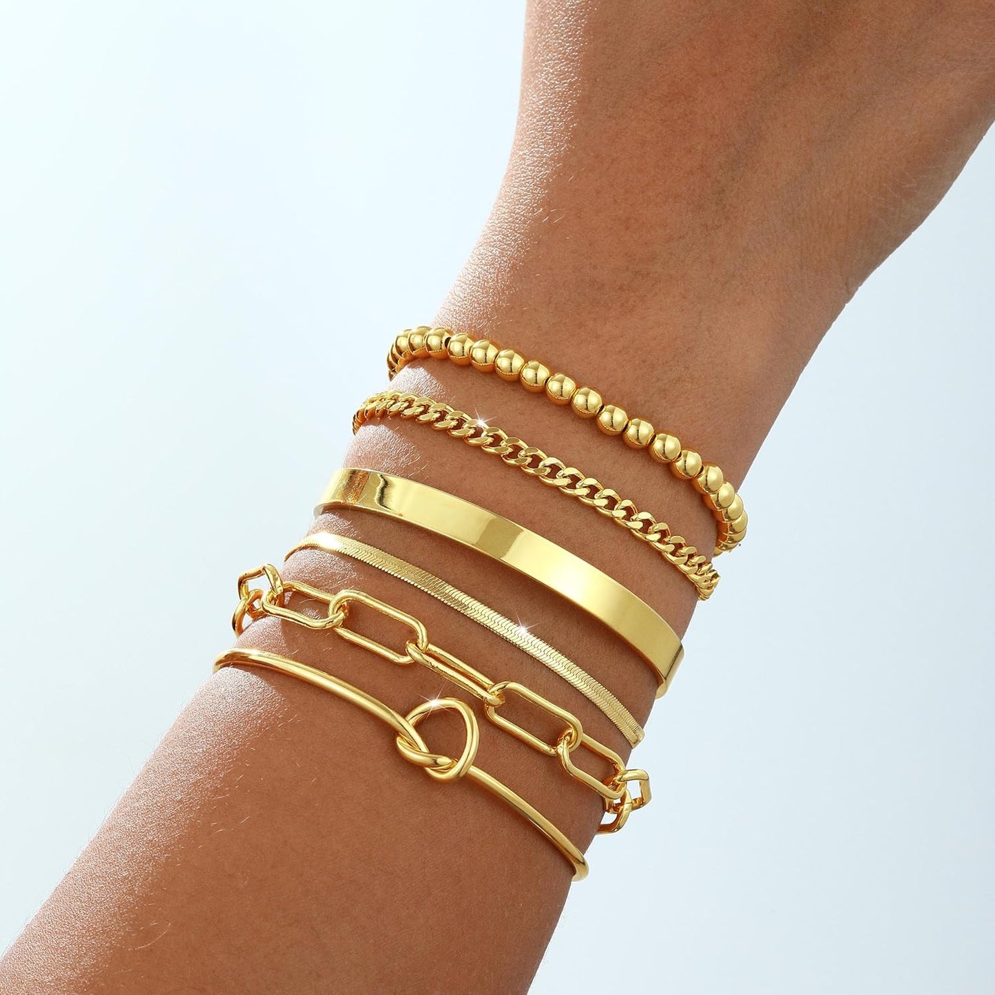 Stacked 14K gold bangle bracelets worn together