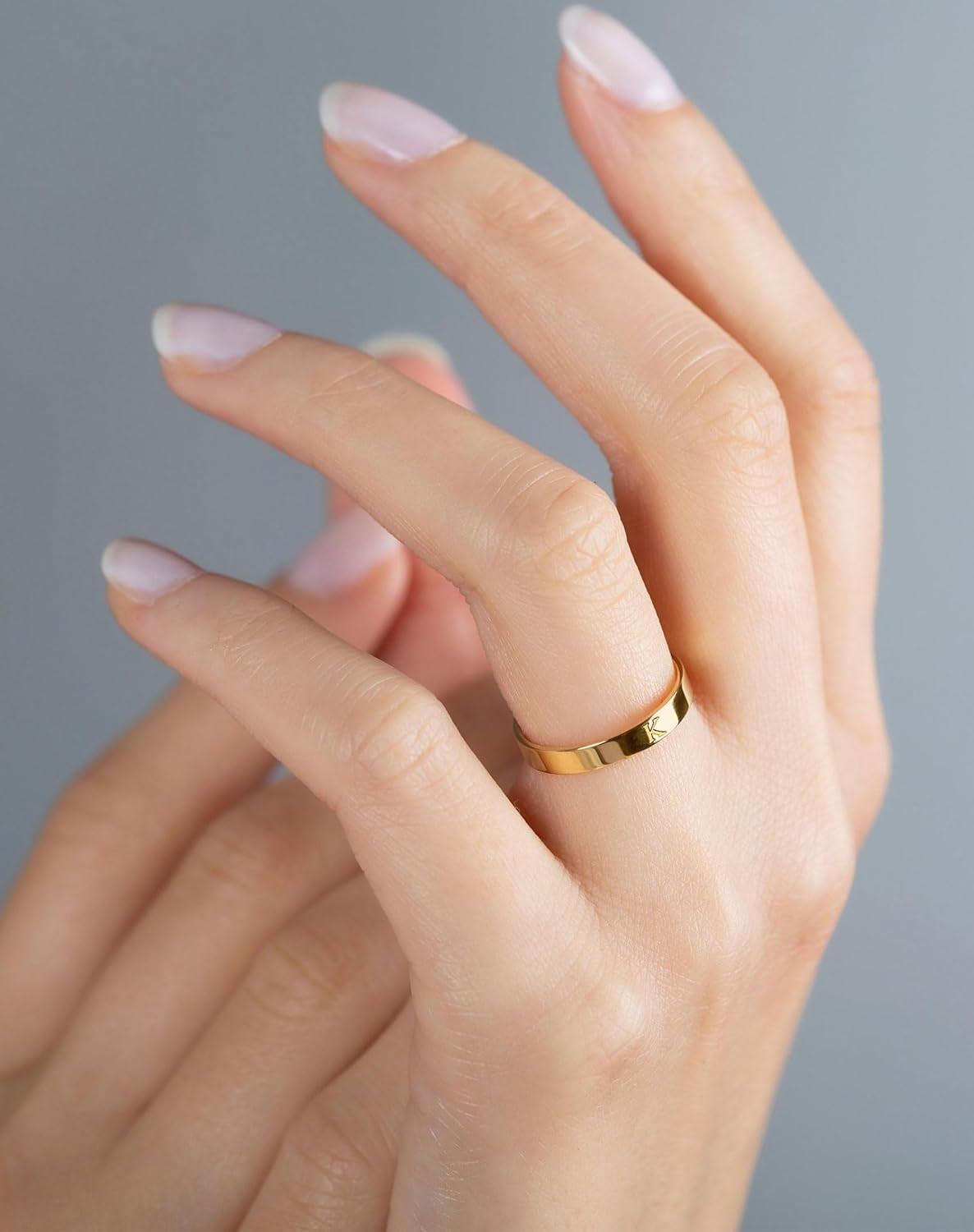 Gold initial rings displayed showing multiple letter options