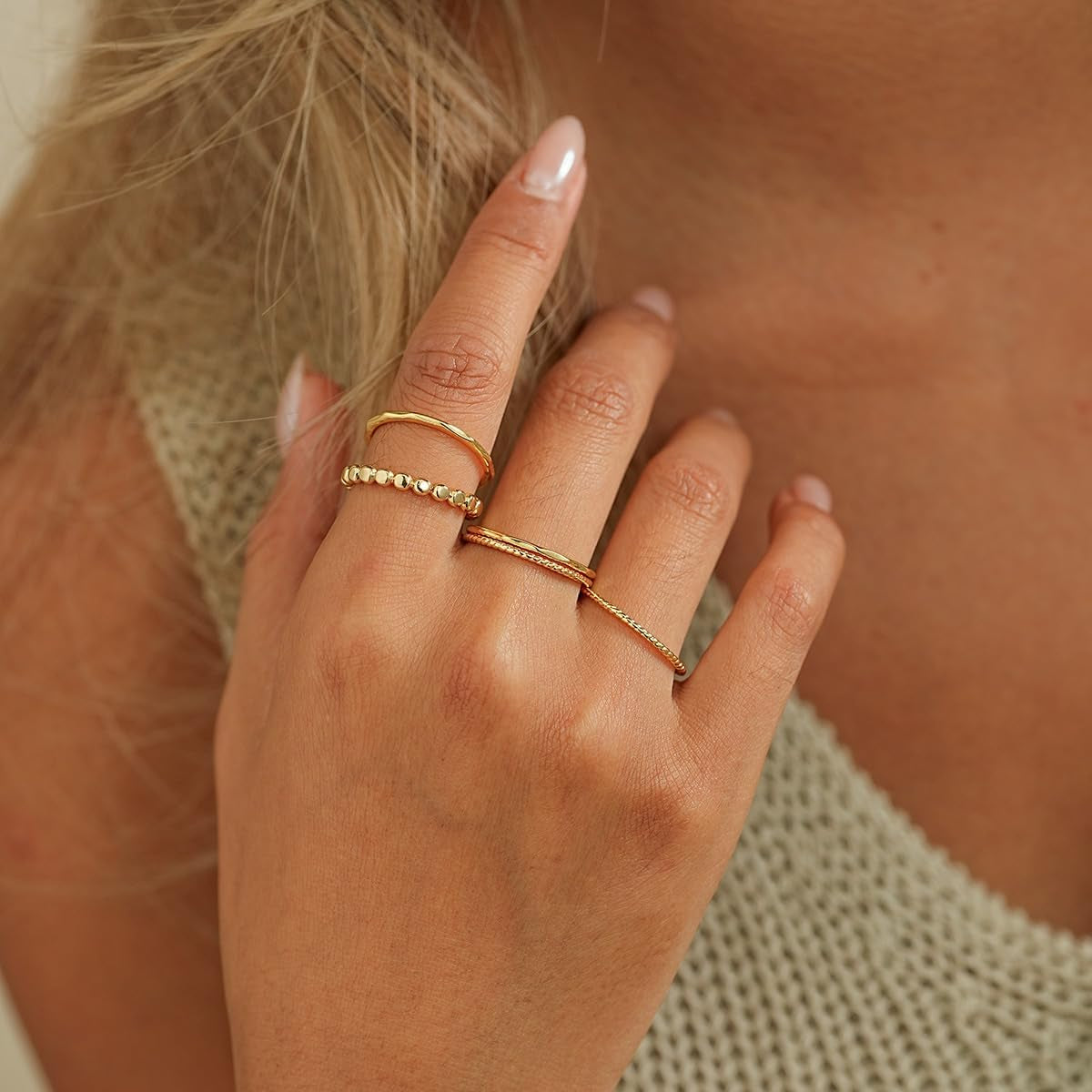 Hypoallergenic gold ring set worn stacked on multiple fingers