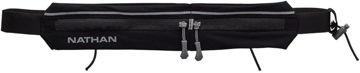 Woman wearing Nathan Mirage compact black running belt during workout