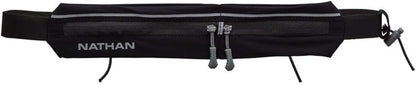 Woman wearing Nathan Mirage compact black running belt during workout
