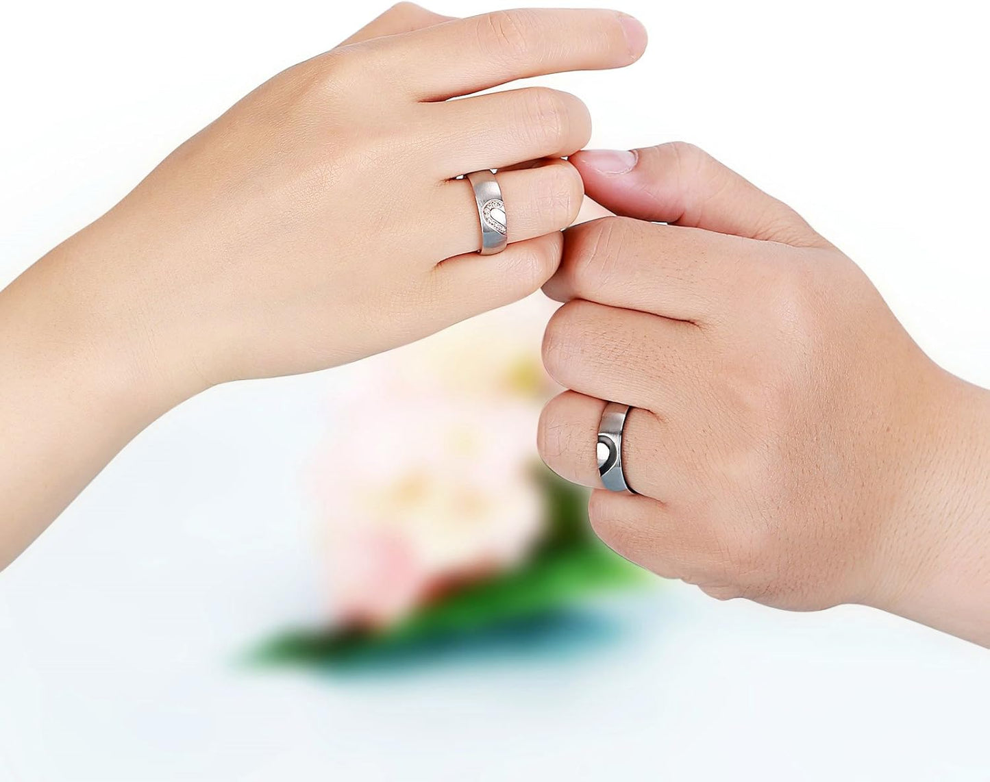 Close-up of interlocking half heart design on promise rings