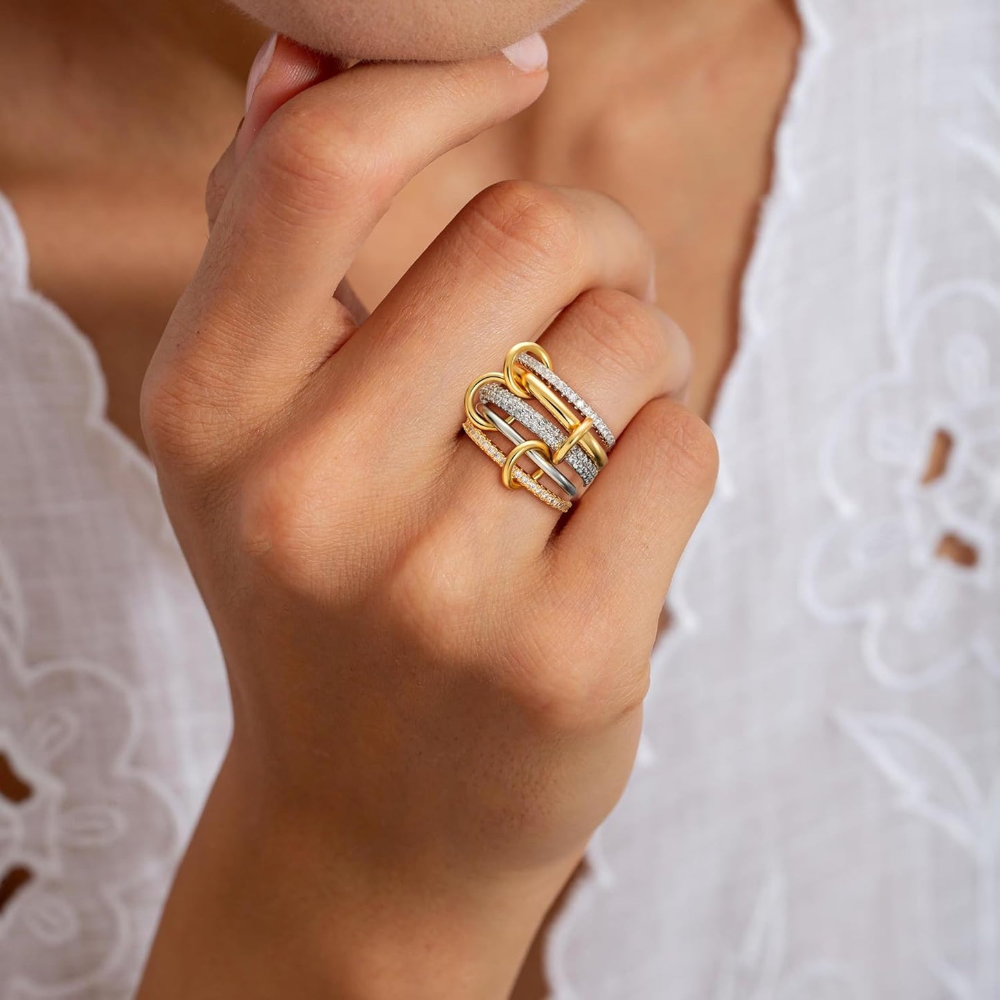 Multiple gold stackable rings stacked on finger
