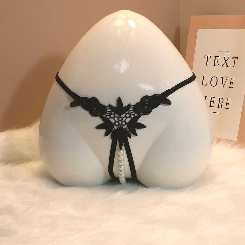 Close-up of intricate pearl pendant on women's thong lingerie