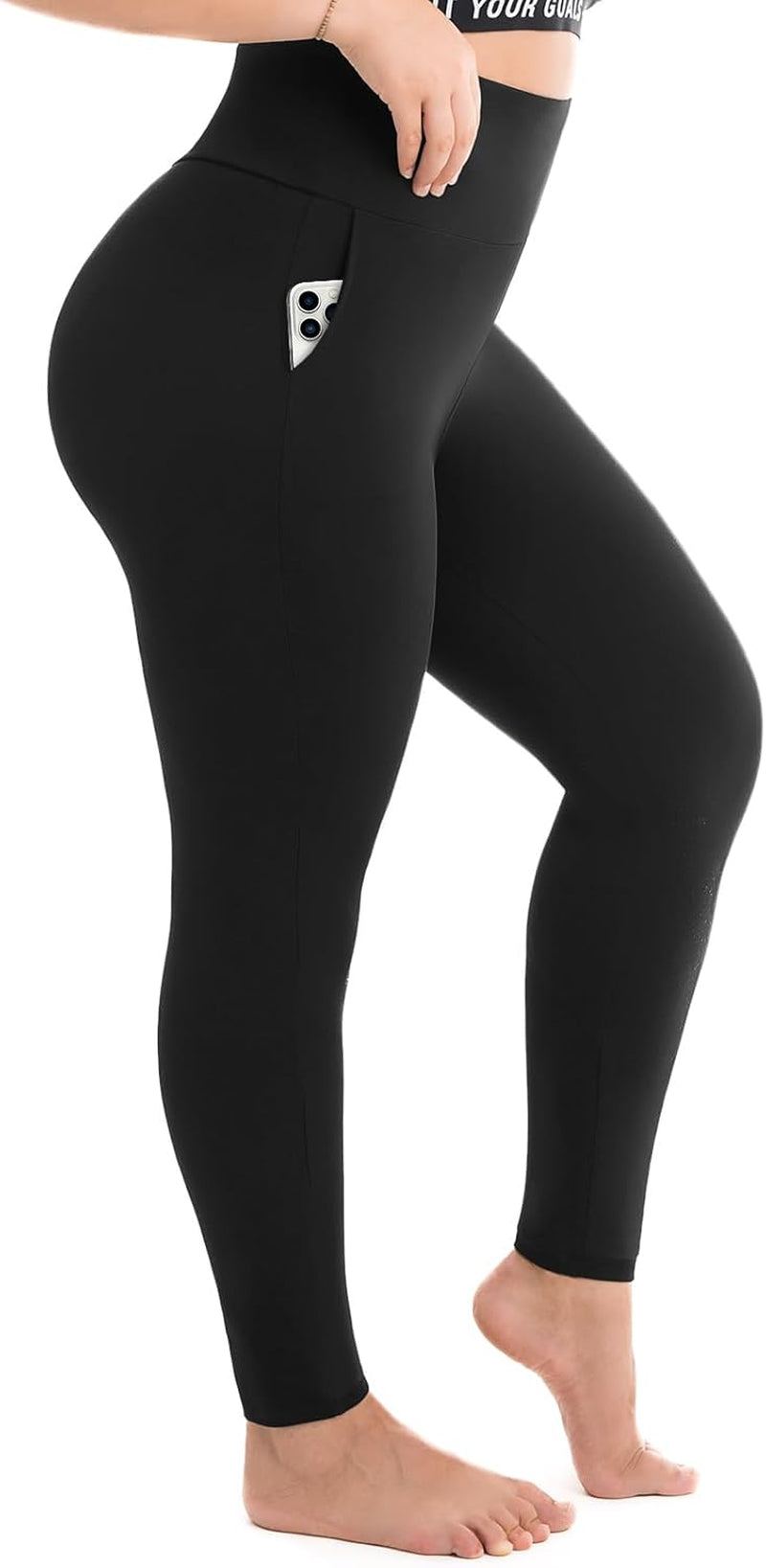 Woman wearing black plus size high-waisted leggings with side pockets