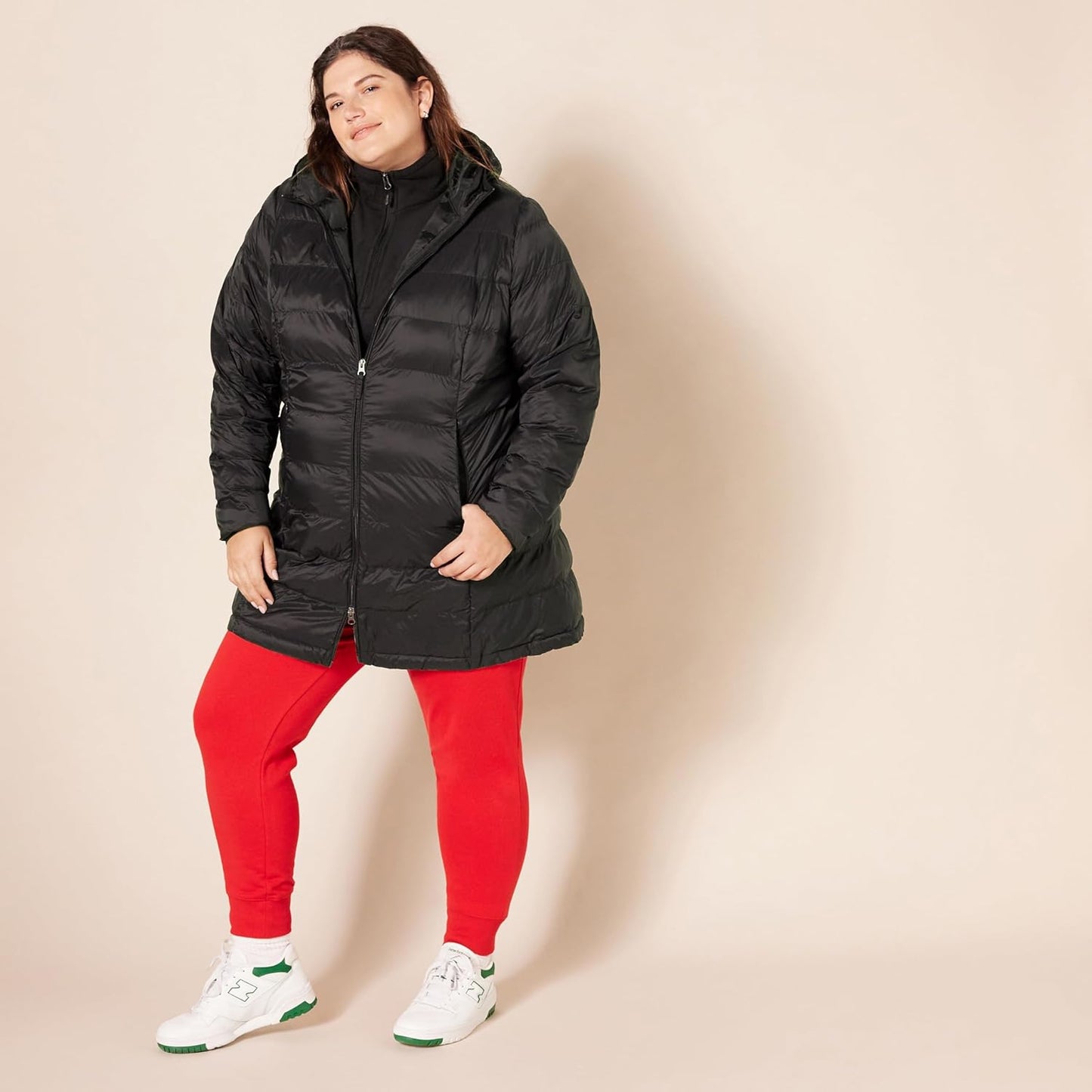 Woman layering puffer coat over different outfits for versatility