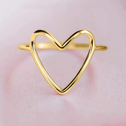 Minimalist heart ring collection showing various metal finishes and styles