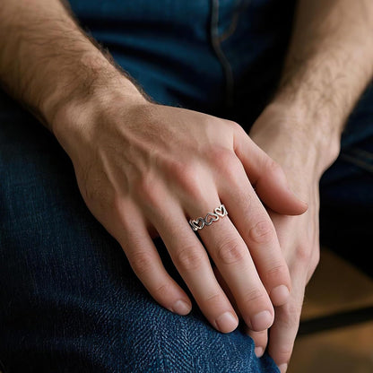 Silver heart ring shown in multiple sizes on woman's fingers