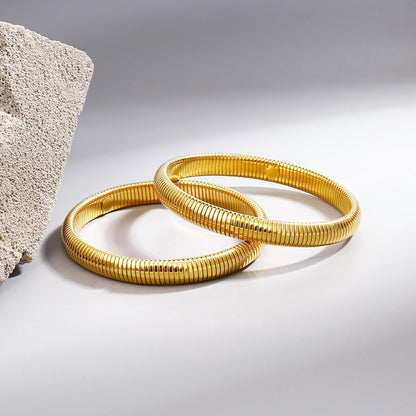 Gold chain link multi-layer bracelet worn by woman