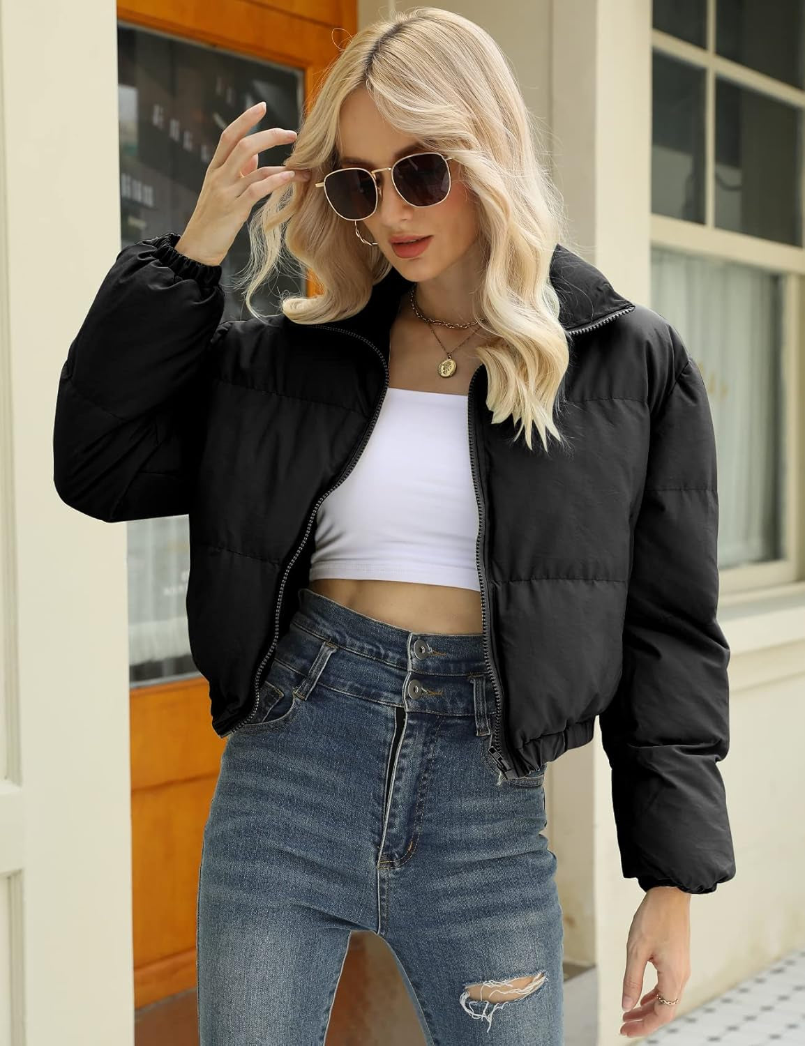 Woman modeling cropped puffer jacket with casual styling