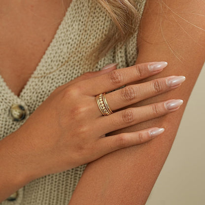 Gold stackable rings displayed individually showing each design