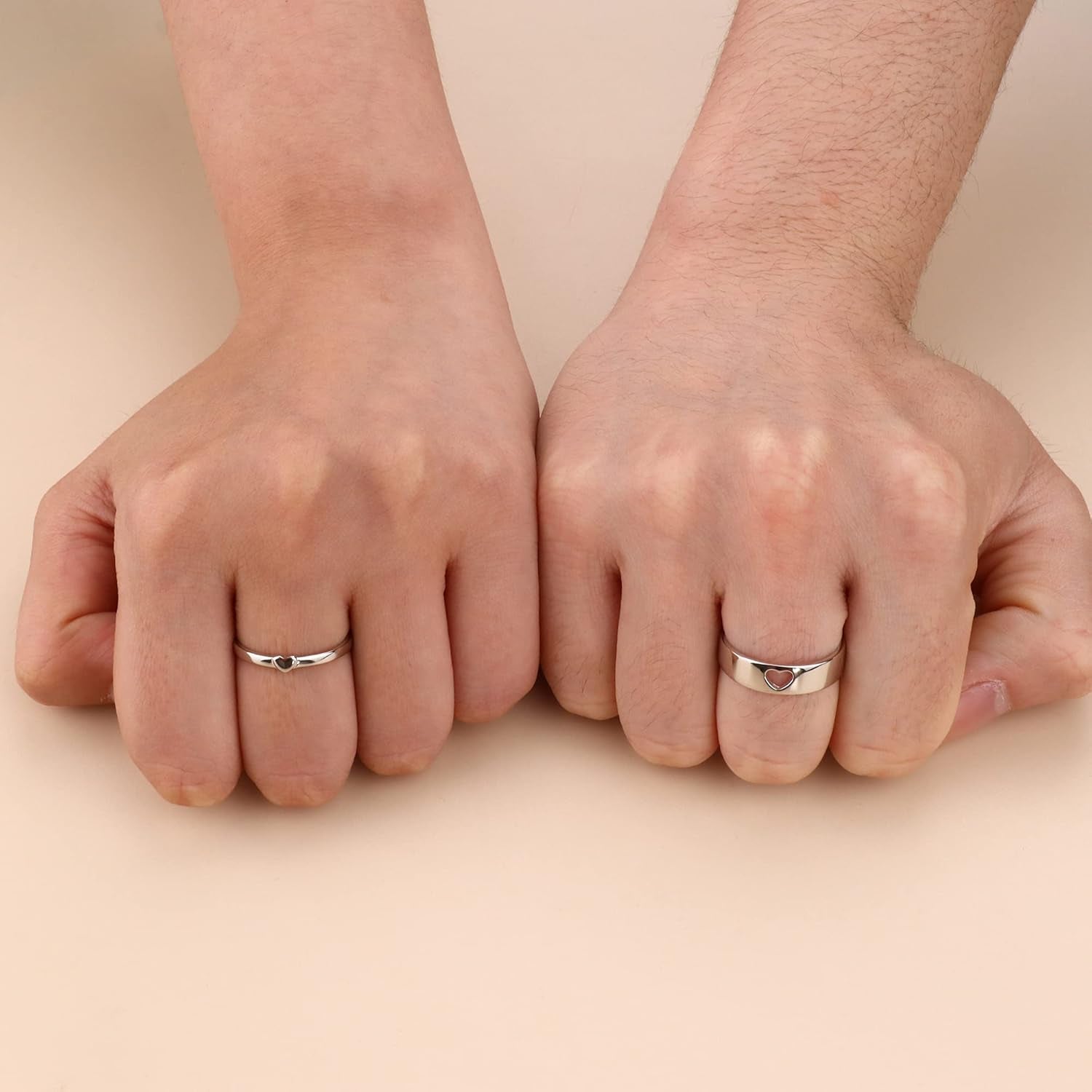 Matching couple's rings with butterfly detail on model hands